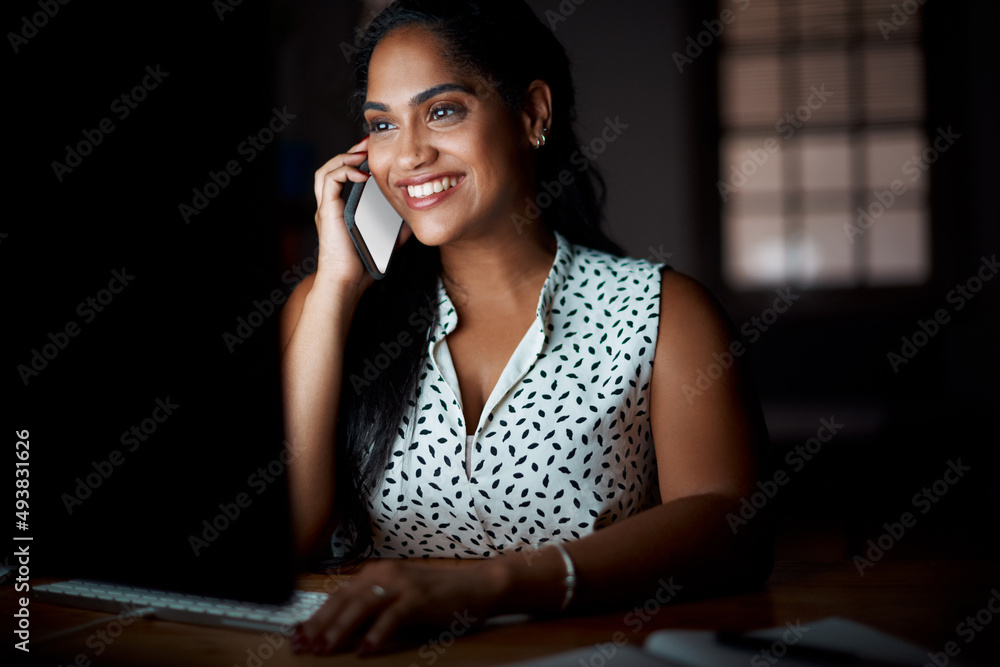 Poster its simply a matter of dedication. shot of a young businesswoman talking on a cellphone while workin