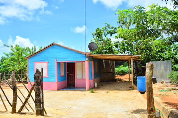 Fototapeta na wymiar Colorful traditional dwelling, house surrounded in green vegetation in Samana Peninsula, in Dominican Republic