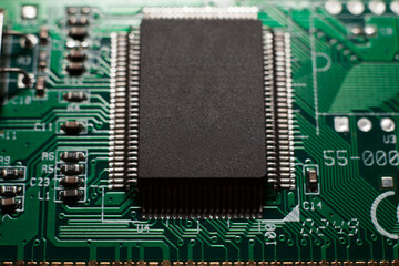 Macro photo of a green computer printed circuit board with selective focus on an blank chip.