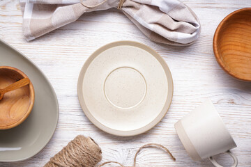 Dishes for serving and eating meals, top view. Modern ceramic and wooden crockery, trendy tableware.