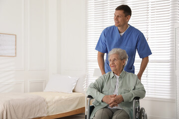Fototapeta premium Caregiver assisting senior woman in wheelchair indoors. Home health care service