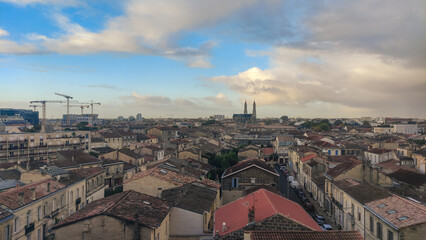 Fototapeta premium Bordeaux houses and streets view from above. Aerial view of tiled rooftops
