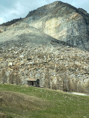 An old House in front of the Big Rock Slide of Randa in the Canton of Wallis of the Year 1991 in...