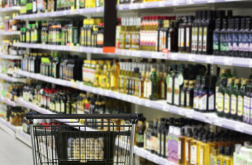 choosing a dairy products at supermarket.empty grocery cart in an empty supermarket