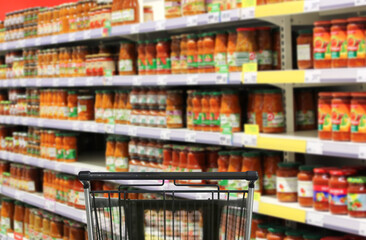 choosing a dairy products at supermarket.empty grocery cart in an empty supermarket