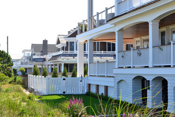 Beach houses with railings and white vinyl fencing