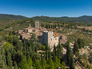 Fototapeta na wymiar aerial view of old town in tuscany country - medieval castle - blue sky and green land