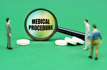 On a green surface are pills, miniature figures of people and a magnifying glass with the inscription Medical Procedure