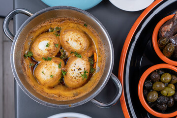 Close-up shot of top angle shot with selective focus on gray background in isolated setting, view from Turkish traditional food of closed egg on breakfast table.