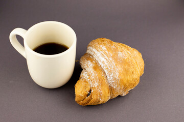 croissant with coffee on a black background