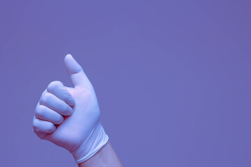 Hands in rubber gloves making the symbol 