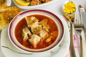 Traditional Turkish Ramadan iftar table with chopped Ramadan Bread into the soup