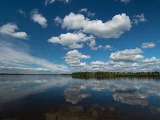Summer day. River. Clouds over the river 