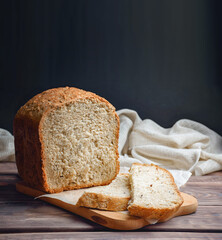 Homebaked bread sourdough  bread with seeds cut into slices lies on a cutting board. Loaf of bread , healthy breakfast.