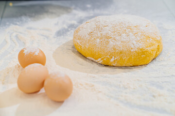dough, flour and eggs on the table. homemade baking and cooking school.