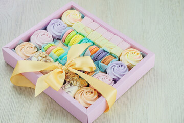 Traditional colored sweet desserts in box for the holiday, copy space. Desserts: macaroons,...