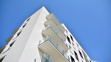 Modern european residential architecture on a sunny day. Exterior of new multi-story residential building. Concept of sale and rental of apartments for  consumers .Modern windows and balconies.