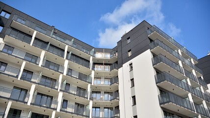 Modern european residential architecture on a sunny day. Exterior of new multi-story residential building. Concept of sale and rental of apartments for  consumers .Modern windows and balconies.