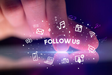 Finger touching tablet with social media icons concept