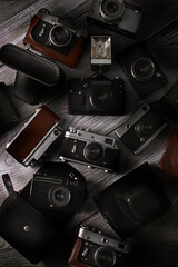 old soviet film cameras with flash on wooden background