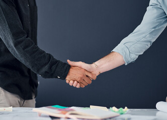 Partnering up for success. Shot of two unrecognizable businessman shaking hands in a modern office.