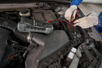 Close-up photo of man working with device and diagnoses machine