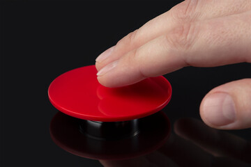 The hand presses the big red button. The concept of the threat of nuclear war. A threat to the...