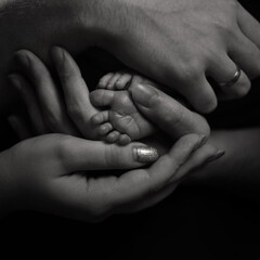 newborn's feet in parental hands