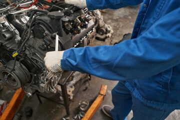 Mechanic holding tool in hands and repairing
