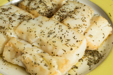 Close up of cod dish in sauce with spices.