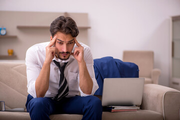 Young male employee working from home during pandemic