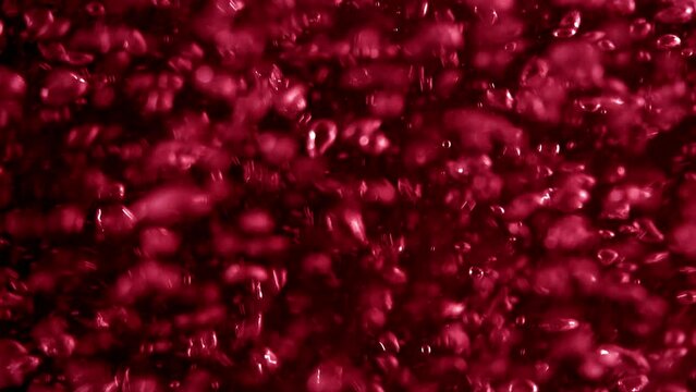 full-frame red sparkling soda lemonade rising carbonated gas bubbles background. Concept 3D animation loop for bubbly fizz alcoholic, fruit drink and as effervescent beverage product backdrop template