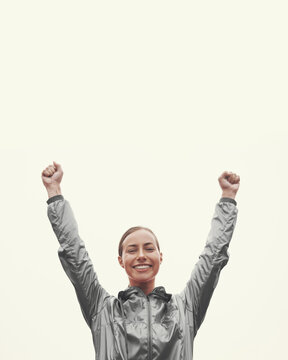 My Personal Best. Shot Of A Young Woman Standing With Her Arms Raised In Victory While Out For An Early Morning Run.