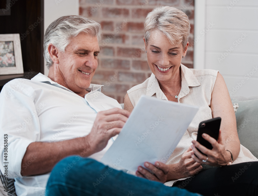 Poster good health should be your biggest goal. shot of a mature couple looking at paperwork while using a 