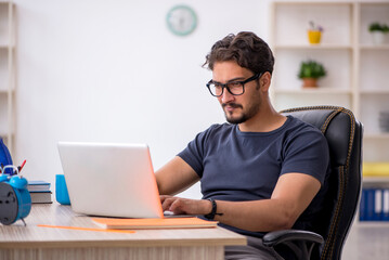 Young male designer working in the office