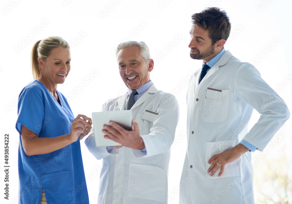 Poster working together to help keep you well. cropped shot of a group of medical practitioners discussing 