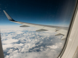 View from the window on the wing of the plane and passing clouds