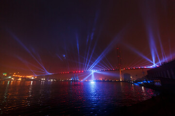Light show of the Golden Bridge in Vladivostok. Bridge across the Golden Horn Bay at night.