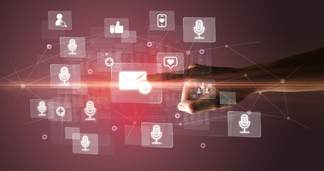 Hand pressing social media multimedia application screen with media icons on futuristic concept