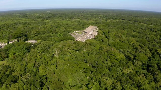 Aerial view around the ruins of Maya temples in EK Balam, sunny Mexico - orbit, drone shot