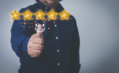 Businessman show hand thumb rises up with virtual five yellow stars. Evaluation the customer satisfaction and service. Products and service evaluation concept.