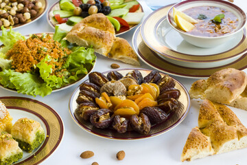 Traditional Ramadan Dinner-Iftar menu designed with elegant dinnerware;soup,dry date fruits,salad,and sliced bread