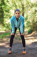 Ready to conquer this trail. Portrait of a woman taking a breather while out for a train run.