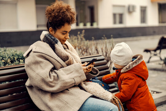 Irresponsible Babysitter Hanging On The Phone And Doesn't Pay Attention To The Little Boy.