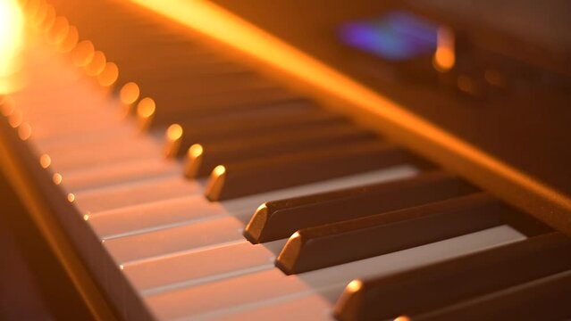 Musician or composer plays piano or midi keyboard in recording studio.Creative dramatic light.Concept of music