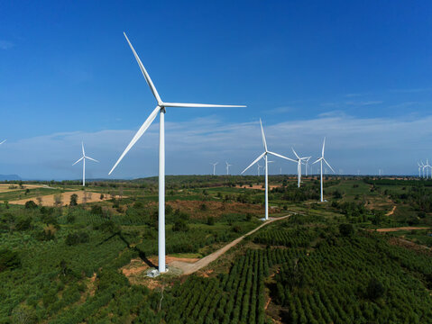Aerial view of wind turbine . Sustainable development, environment friendly, renewable energy concept.Windmill in the morning on blue Sky. wind turbine in feilds.