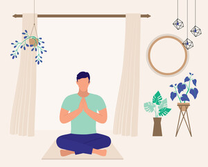 Young Man Sitting Cross-Legged Doing Yoga At His Cozy Living Room.