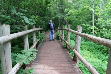 Fototapeta premium person walking on a bridge