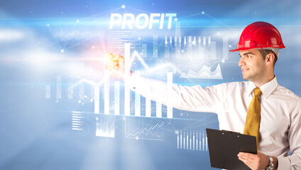 Young businessman with helmet drawing on virutal screen