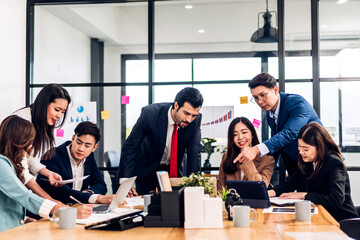 Group of asian business meeting and discussing strategy startup project analysis finance process.Success business people work plan and brainstorm marketing idea with laptop in office.Teamwork